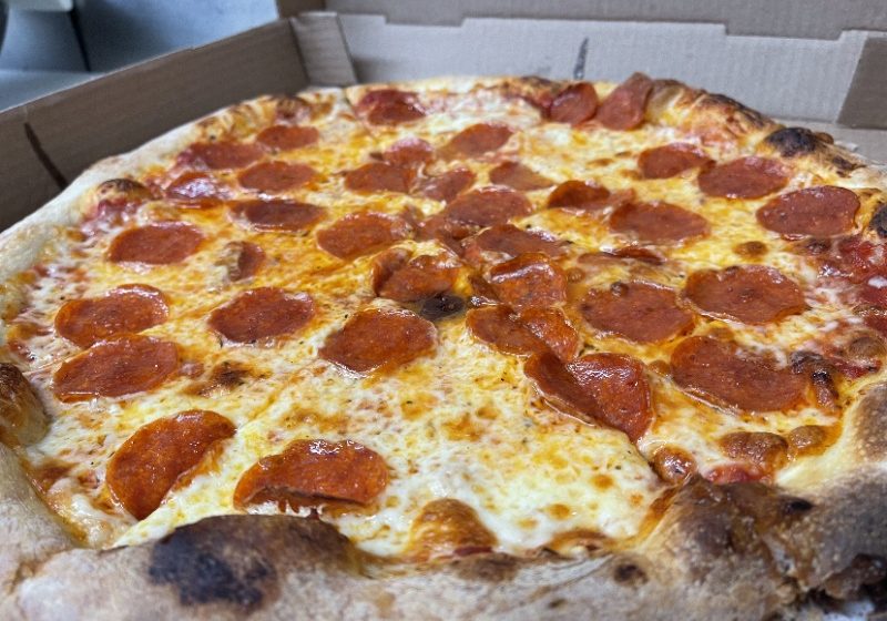 A pepperoni pizza in a box.